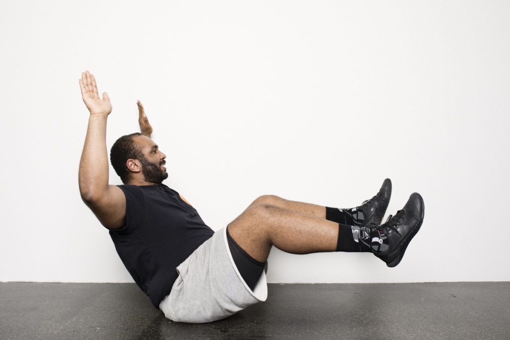 Personal Trainer zeigt FitnessÃ¼bung fÃ¼r Bauch